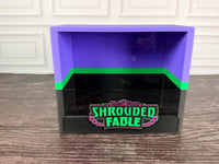 Shrouded Fable purple green black ETB display case front view with raised logo plate