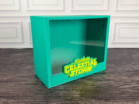 Teal green Celestial Storm ETB display case, angled view with raised bright green logo